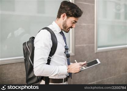 side view man using digital tablet