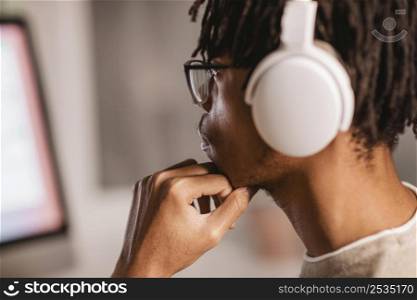 side view man using modern headphones