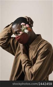 side view man wearing face mask flowers