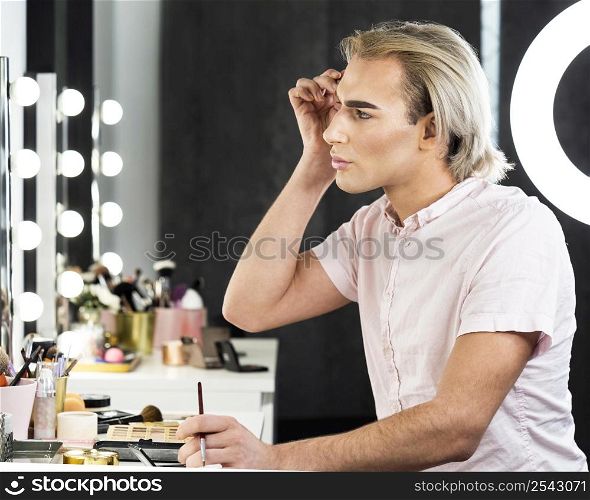 side view man wearing make up