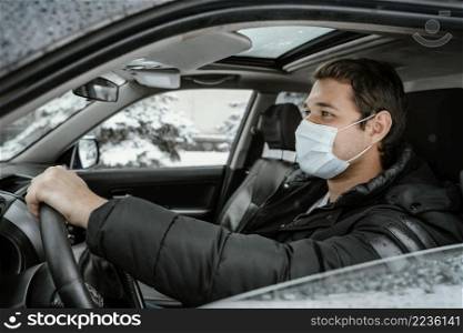 side view man with medical mask driving car road trip
