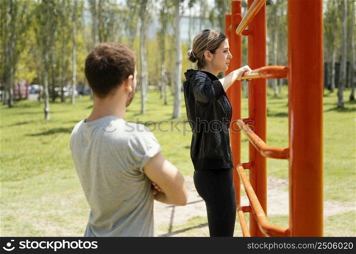 side view man woman exercising together outdoors