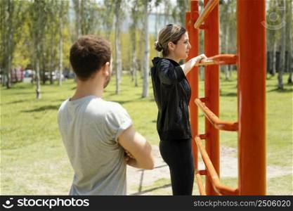 side view man woman exercising together outdoors