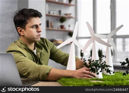 side view man working eco friendly wind power project