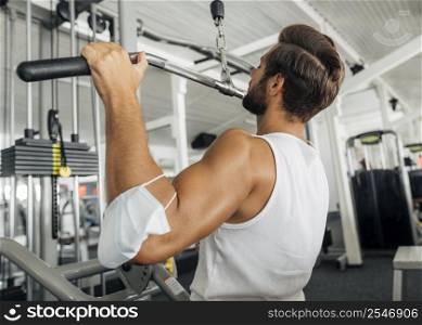 side view man working out gym with medical mask his forearm