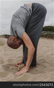 side view man yoga position outdoors