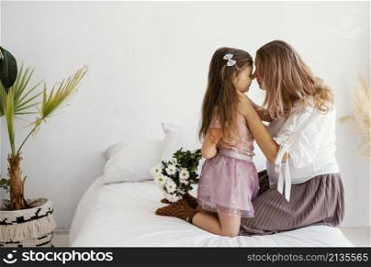 side view mother daughter with bouquet spring flowers