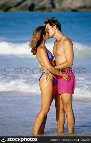 Side view of a couple smooching each other, Horse-shoe Bay beach, Bermuda