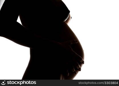 Side view of a naked pregnant woman