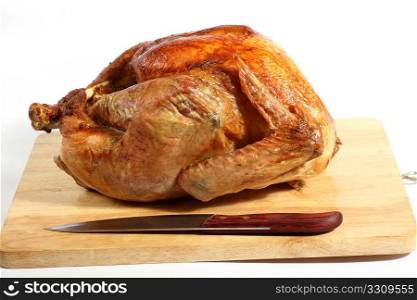 Side view of a roasted turkey on a chopping board