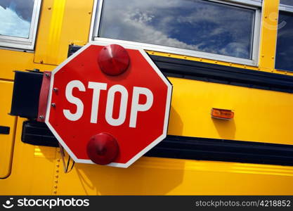 Side view of a school bus and its stop signal.