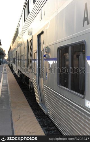 Side view of a train standing in a station.