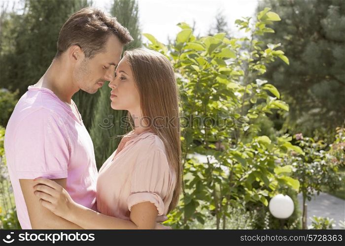 Side view of affectionate young couple in park