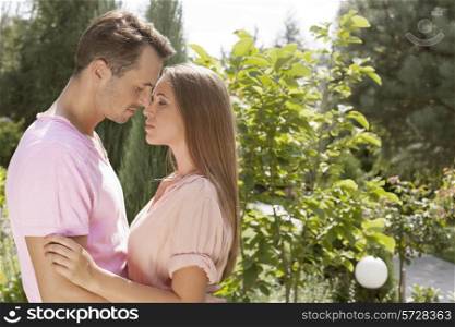 Side view of affectionate young couple in park