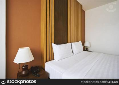 Side view of bedroom interior with minimal style decoration with pillows mock up for hotel apartment, Clean room