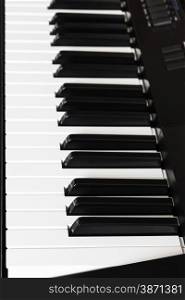 side view of black and white keys of digital piano close up
