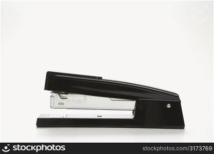 Side view of black stapler on white background.