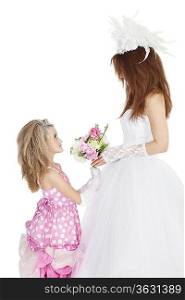 Side view of bride and bridesmaid looking at each other while holding bouquet over white background
