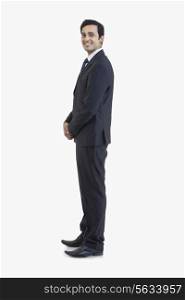 Side view of businessman in suit isolated over gray background