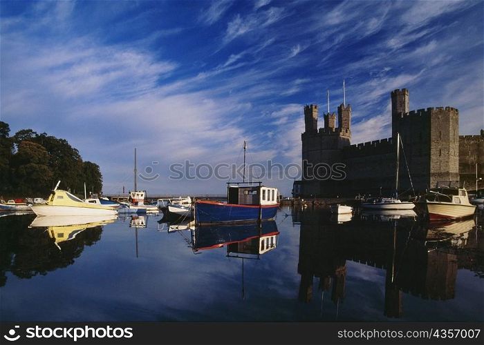 Side view of Caernarvon Castle from a river in Wales