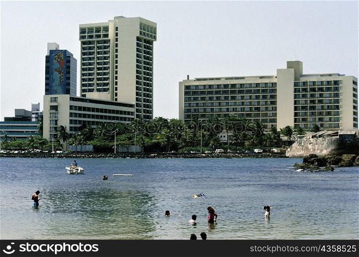 Side view of commercial buildings with a lake in the foreground, San Juan, Puerto Rico