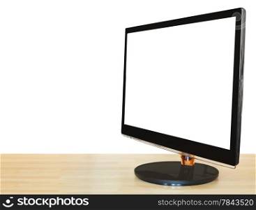 side view of computer black widescreen display with cut out screen on wooden table isolated on white background