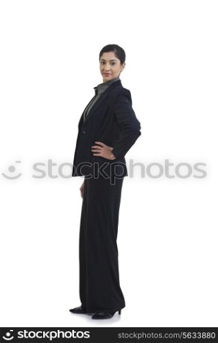 Side view of confident businesswoman with hand on hip isolated over white background