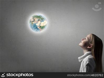 Side view of cute girl and Earth planet above her head. Elements of this image are furnished by NASA. Profile of cute girl