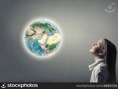 Side view of cute girl and Earth planet above her head. Elements of this image are furnished by NASA. Profile of cute girl