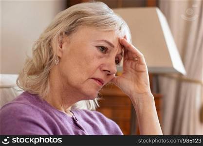 Side View Of Depressed Senior Woman At Home
