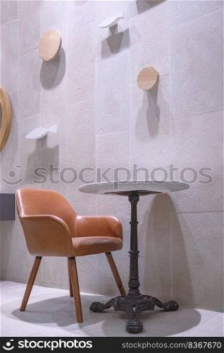 Side view of empty table set beside gray tile wall decoration in minimal style and vertical frame