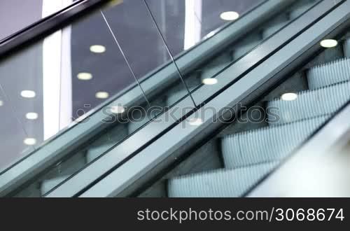 Side view of escalator in the trade centre running up and down