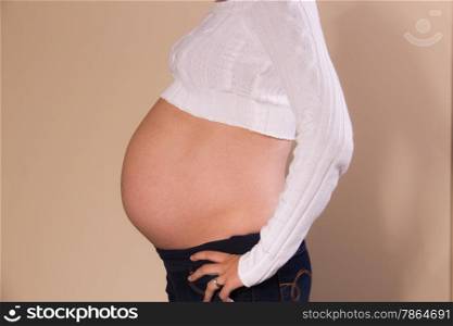 Side view of exposed belly of a pregnant girl