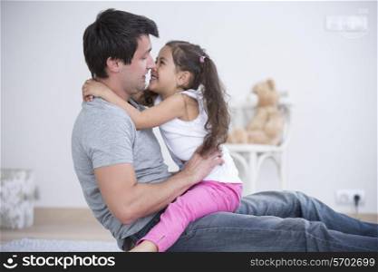 Side view of father and daughter spending quality time at home