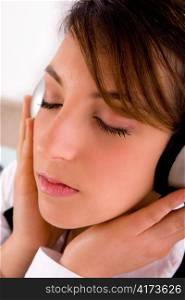 side view of female professional listening to music against white background