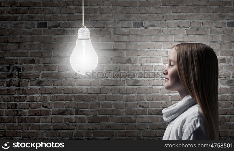 Side view of girl of school age looking at brain above