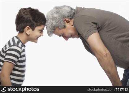 Side view of grandfather and grandson face to face
