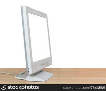 side view of grey display with cut out screen on wooden table isolated on white background