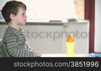 Side view of little boy watching TV