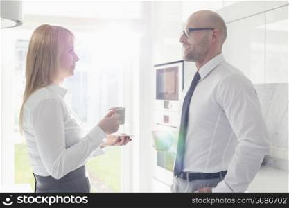 Side view of mid adult business couple talking at home