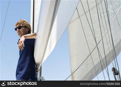 Side view of middle-aged man on yacht
