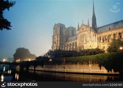 Side view of Notredame Cathedral near a river, Paris, France