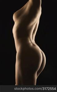 Side view of nude Hispanic mid adult female body.