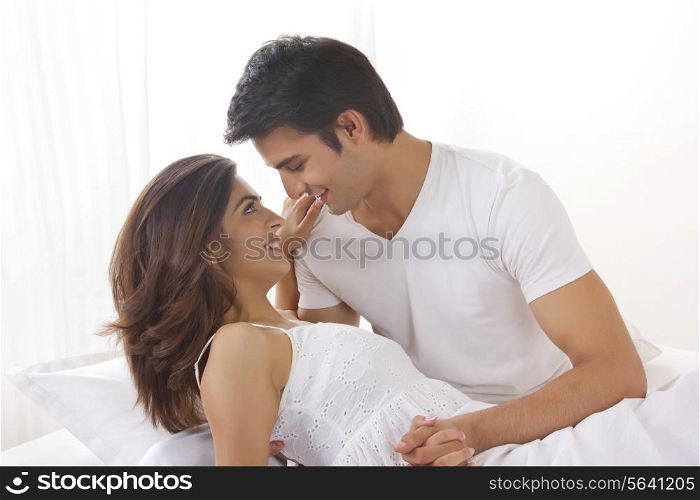 Side view of romantic young couple in bed