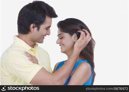 Side view of romantic young couple isolated on white background