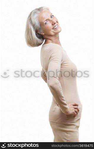 Side view of senior woman in casuals with hands on hips against white background