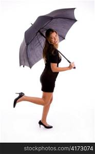 side view of sexy woman carrying umbrella on an isolated white background