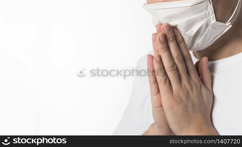 Side view of sick patient with medical mask praying