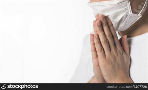 Side view of sick patient with medical mask praying