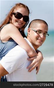 Side view of Smiling young couple piggybacking